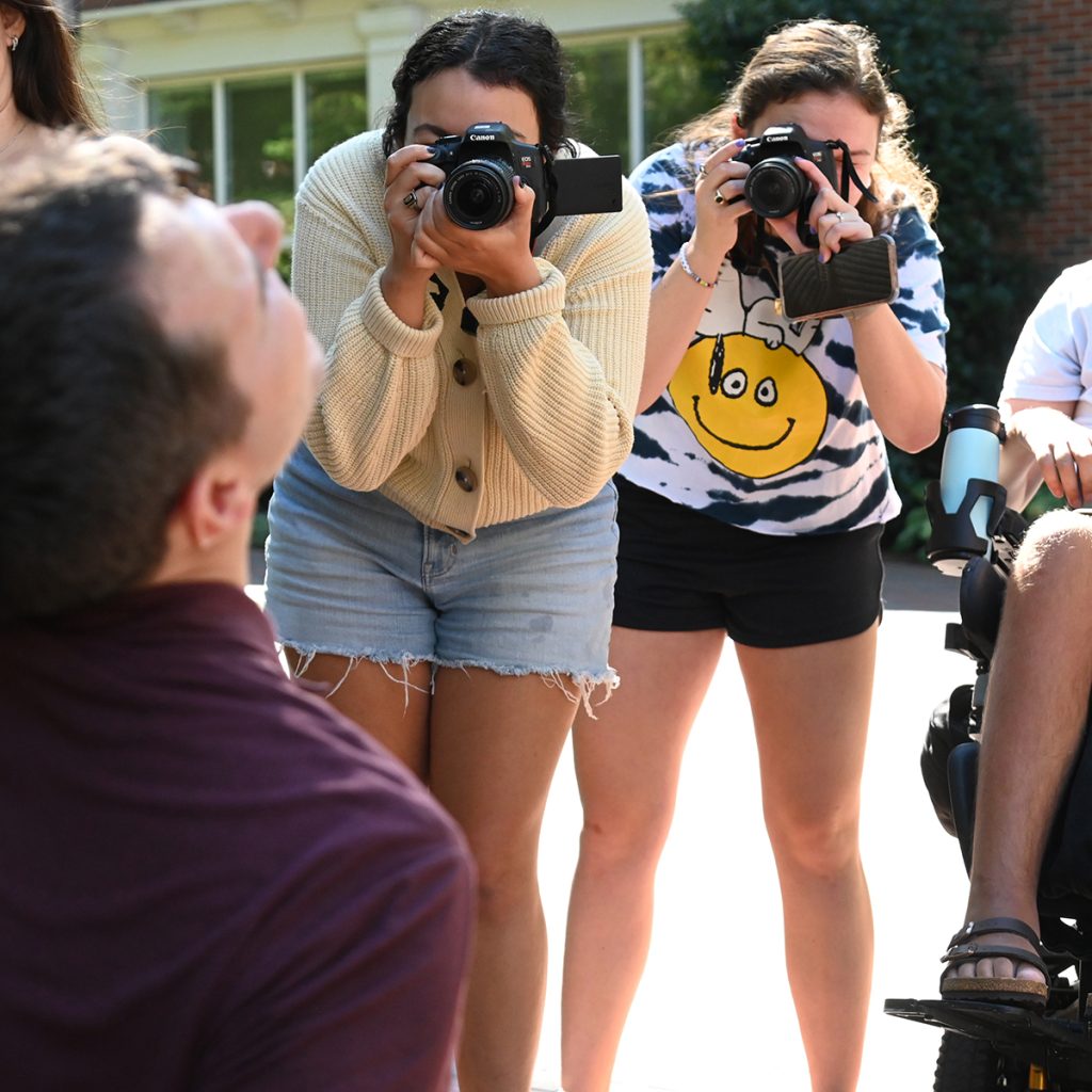 Two female Elon students with cameras