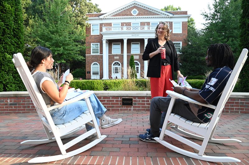 Assistant Professor Shannon Zenner speaks with two students