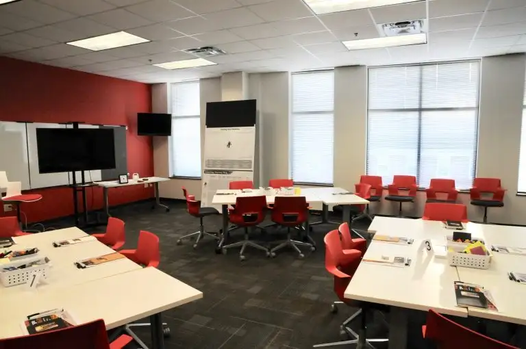 tables and chairs laid out for collaborative workshops in the center for design thinking