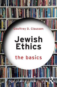 book cover of jewish ethics: the basics by geoffrey d claussen featuring a photo of books on a library shelf