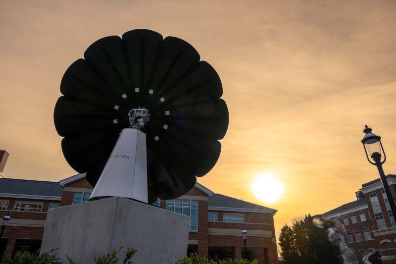 Solar sundial with the sun setting behind it
