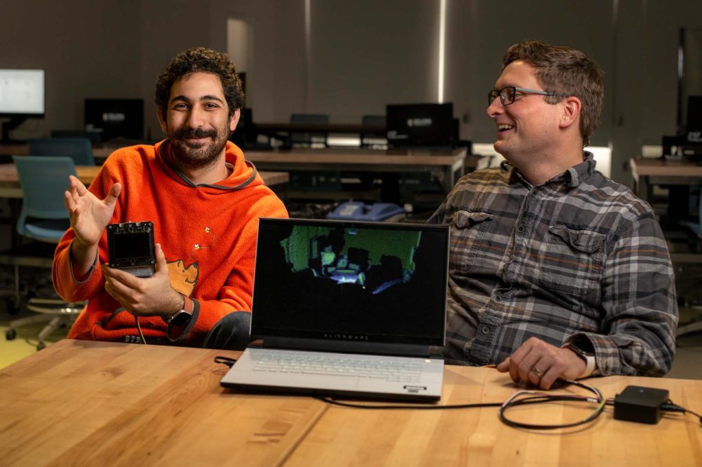 Associate Professor of Computer Science Ryan Mattfield (left) and Rony Dahdal '26 (right) demonstrate LiDAR technology. Dahdal's Lumen Prize research is focused on how to use the technology to detect vital signs.