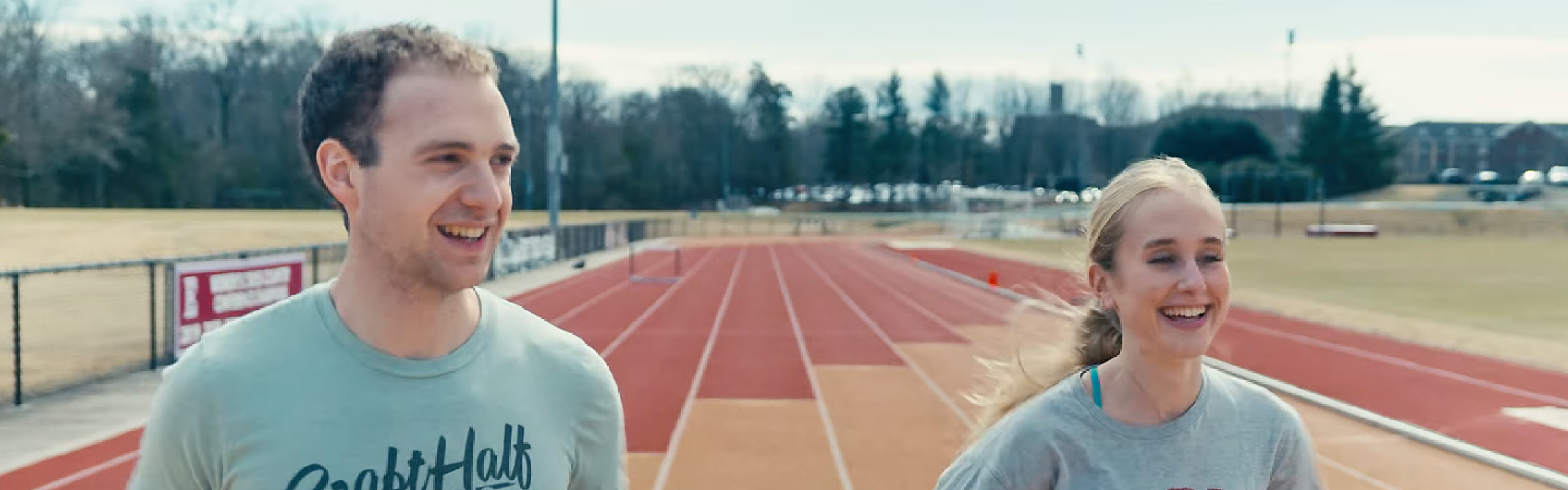 2 students running on a track