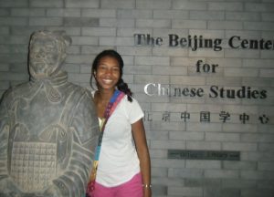 Aisha Mitchell standing next to statue