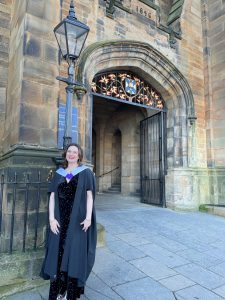 Photo of Diani Teixeira in graduation gown. 