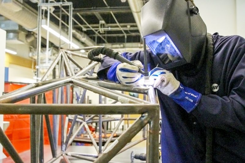 Elon Engineering alumni Jack O'Donnell welding in the Engineering workshop