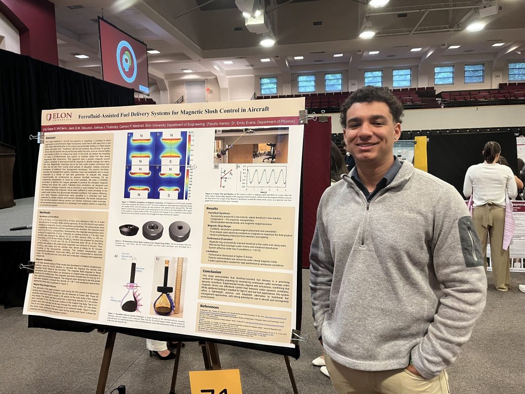 Cannon MArshall stands in front of his presentation poster.