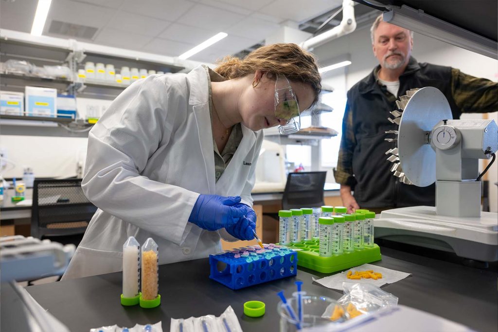 Scott Wolter his student Lauren Hill ’24 testing the novel organic/inorganic composite materials with stormwater in the field