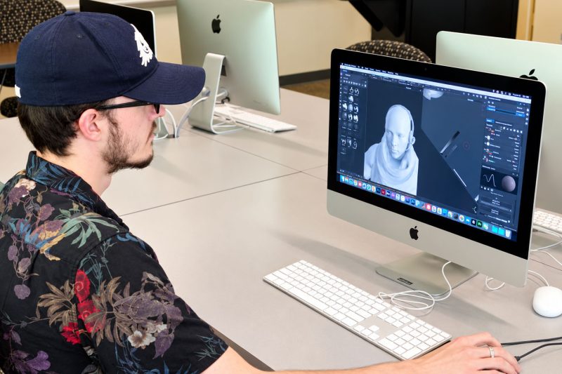A student designs an animated character on a computer screen