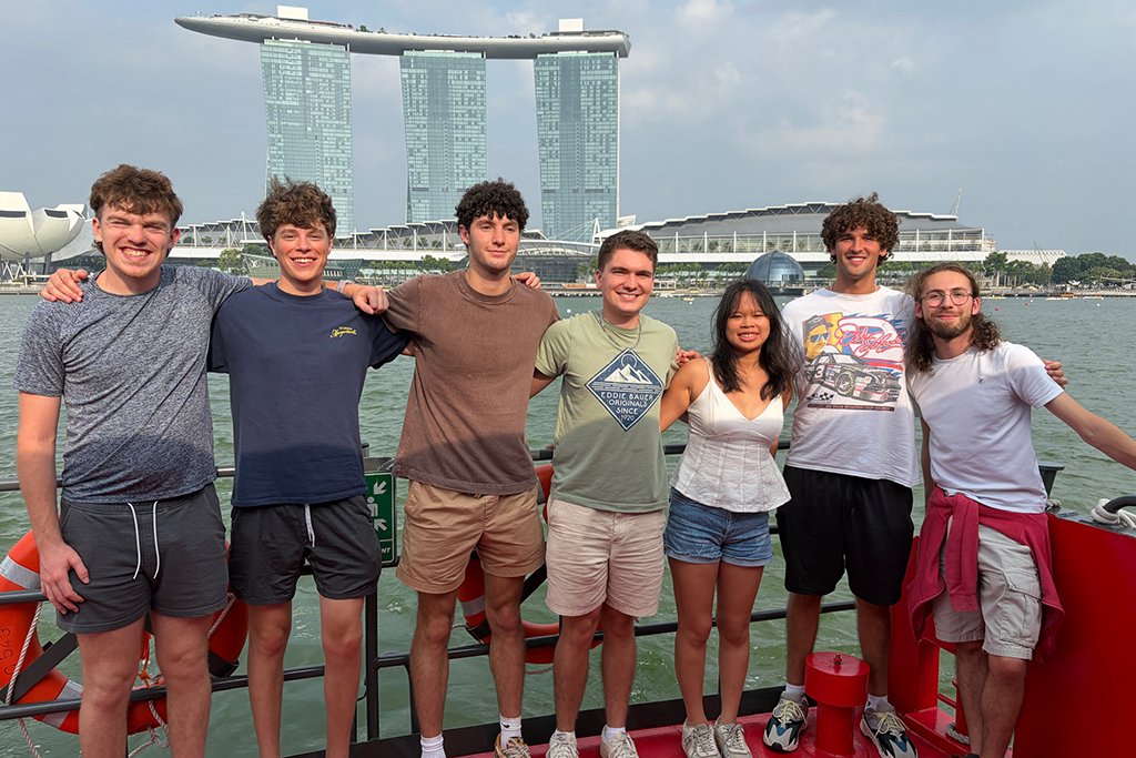 Elon students pose along Singapore’s waterfront with Marina Bay Sands in the background