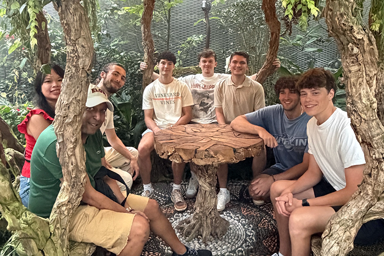 Elon students and faculty gather in a tropical garden during their semester in Singapore.