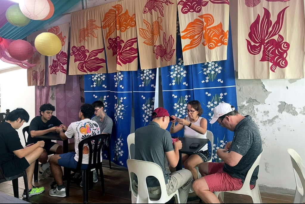 Elon students and faculty participate in a cultural activity during their semester in Singapore.