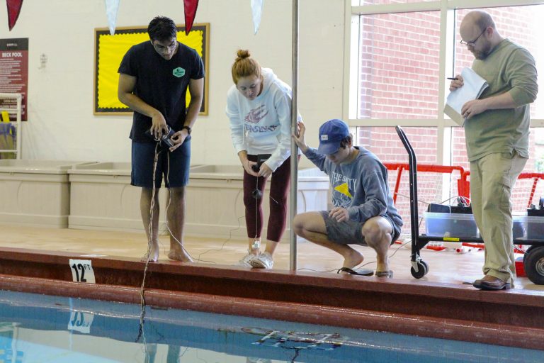 Three students run tests on their underwater ROV