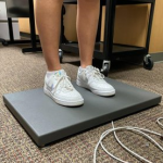 view of person's legs as they stand on a force plate