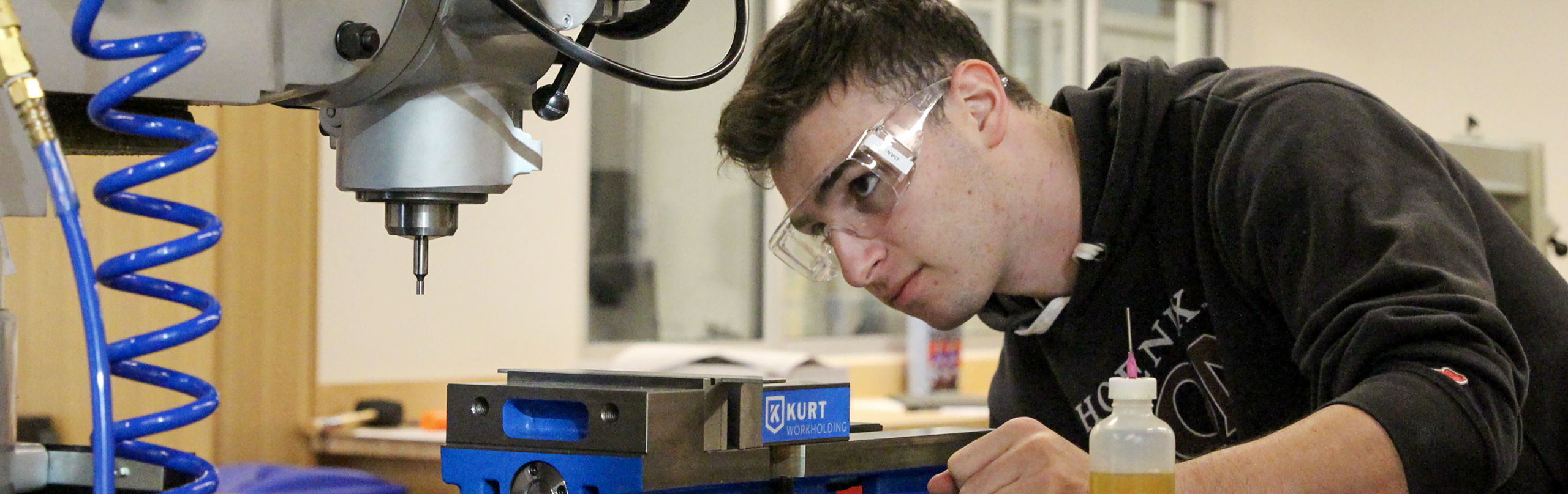A student works with machinery in the Clark Prototype Lab. Explore engineering schools nc for your engineers degree