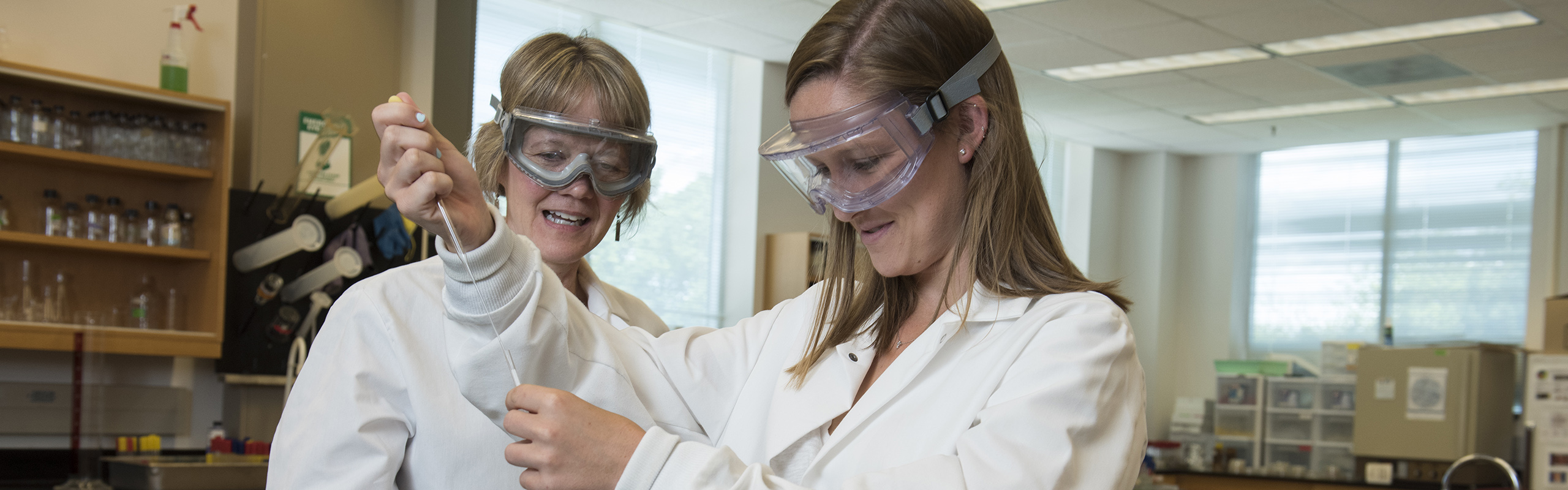 Biochemistry major and Honors Fellow Taylor Glenn '16 poses in a laboratory with associate professor of chemistry Kathy Matera, her research mentor.