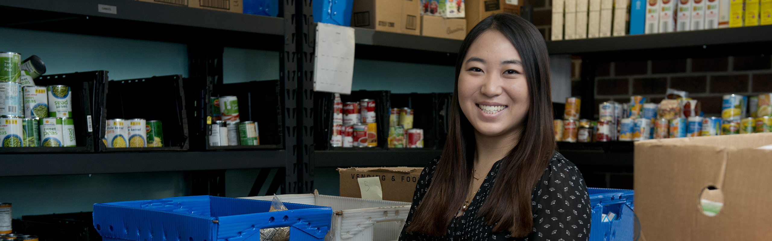 Jenny Fukunaga '17 volunteers at Allied Churches of Alamance County. Here she poses in ACAC's food pantry.