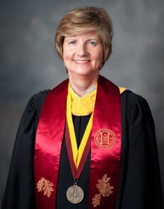 Pam Kiser in robe and academic regalia