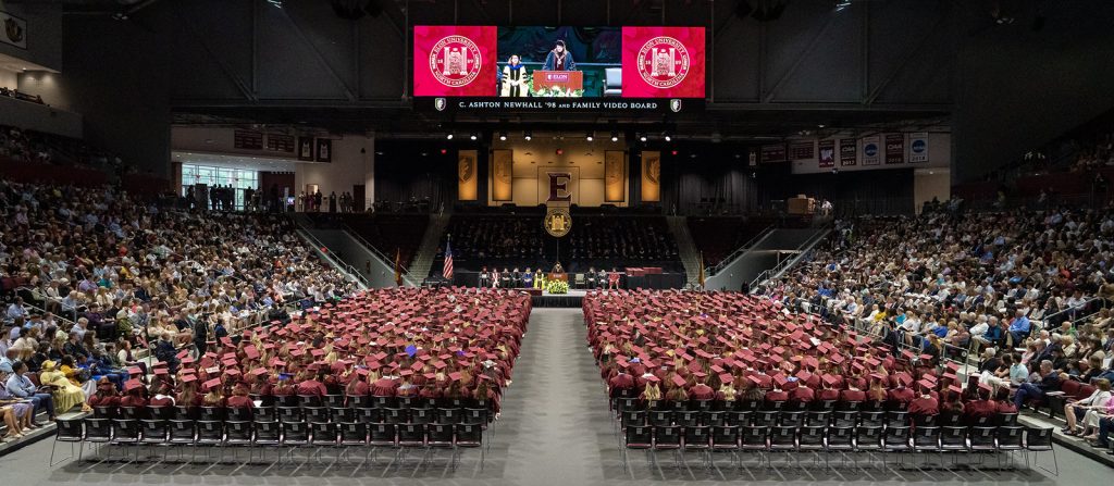 Grads sit in seats in Schar Center during graduation.