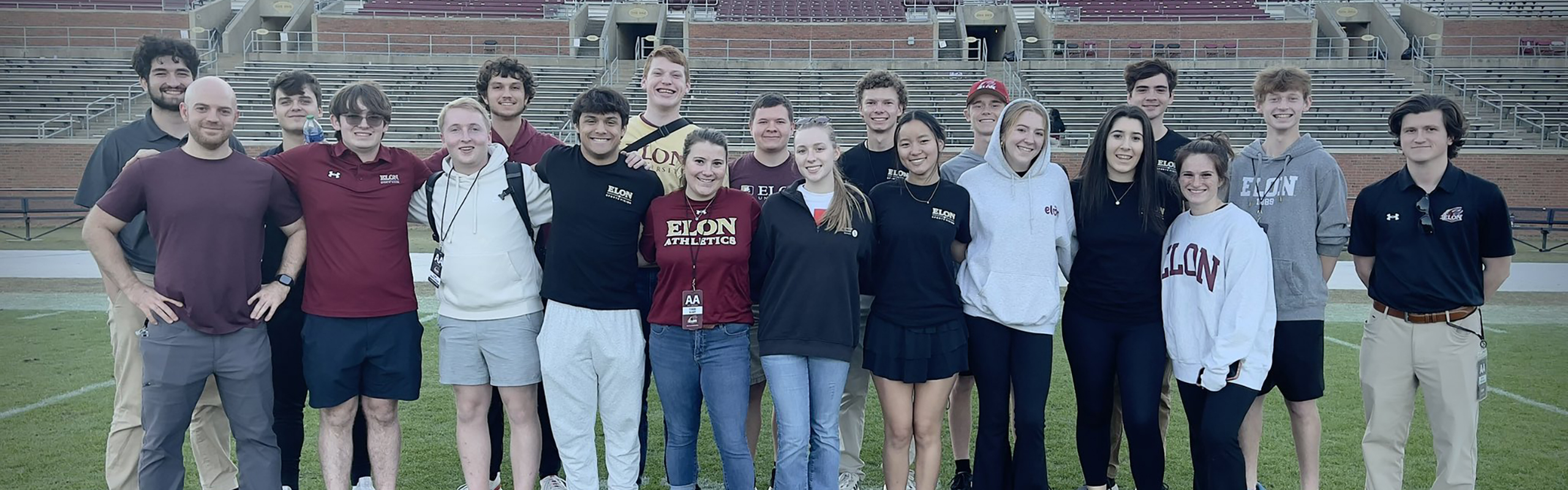 A group of Elon Sports Visions members interested in sports broadcasting and sportscasting, stand together on the Elon football field. Elon is arguably one of the best sports broadcasting schools in the country.