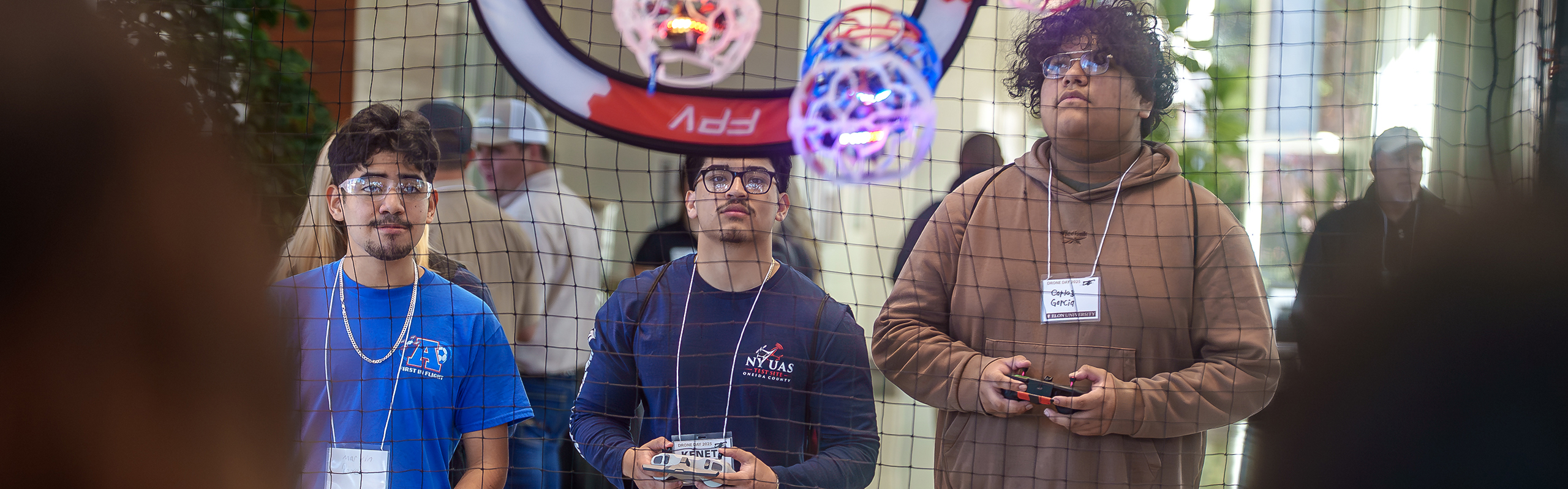 Three Asheboro City Schools students compete in a fast-paced drone soccer match