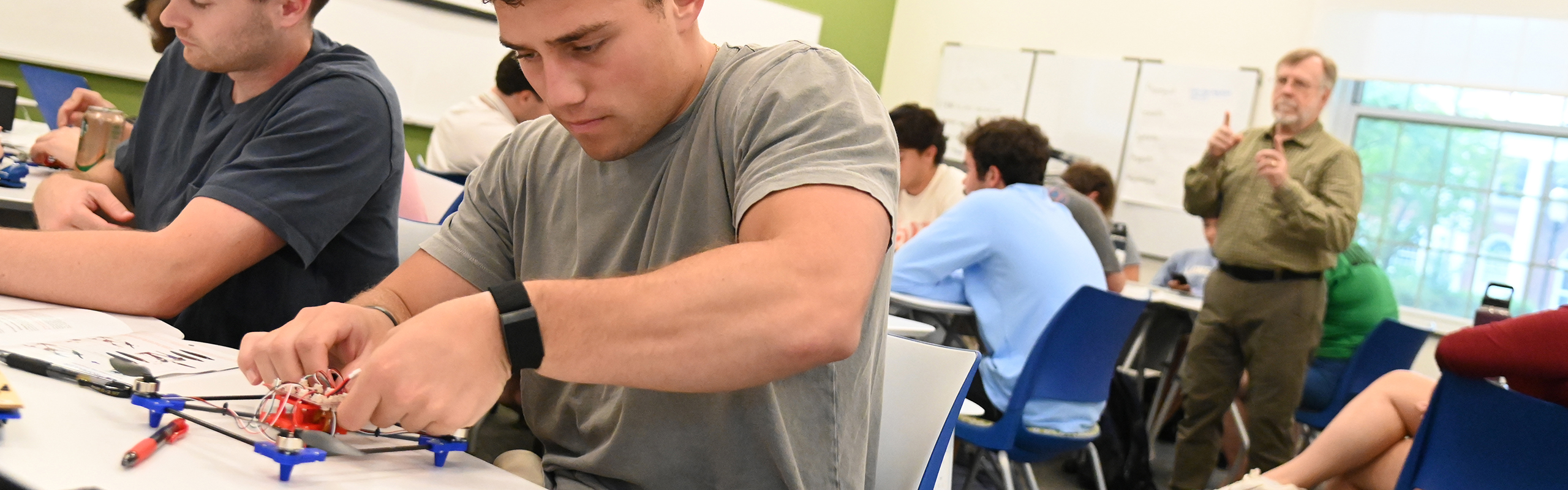 Randy Piland of Elon University explains the assembly of a drone.