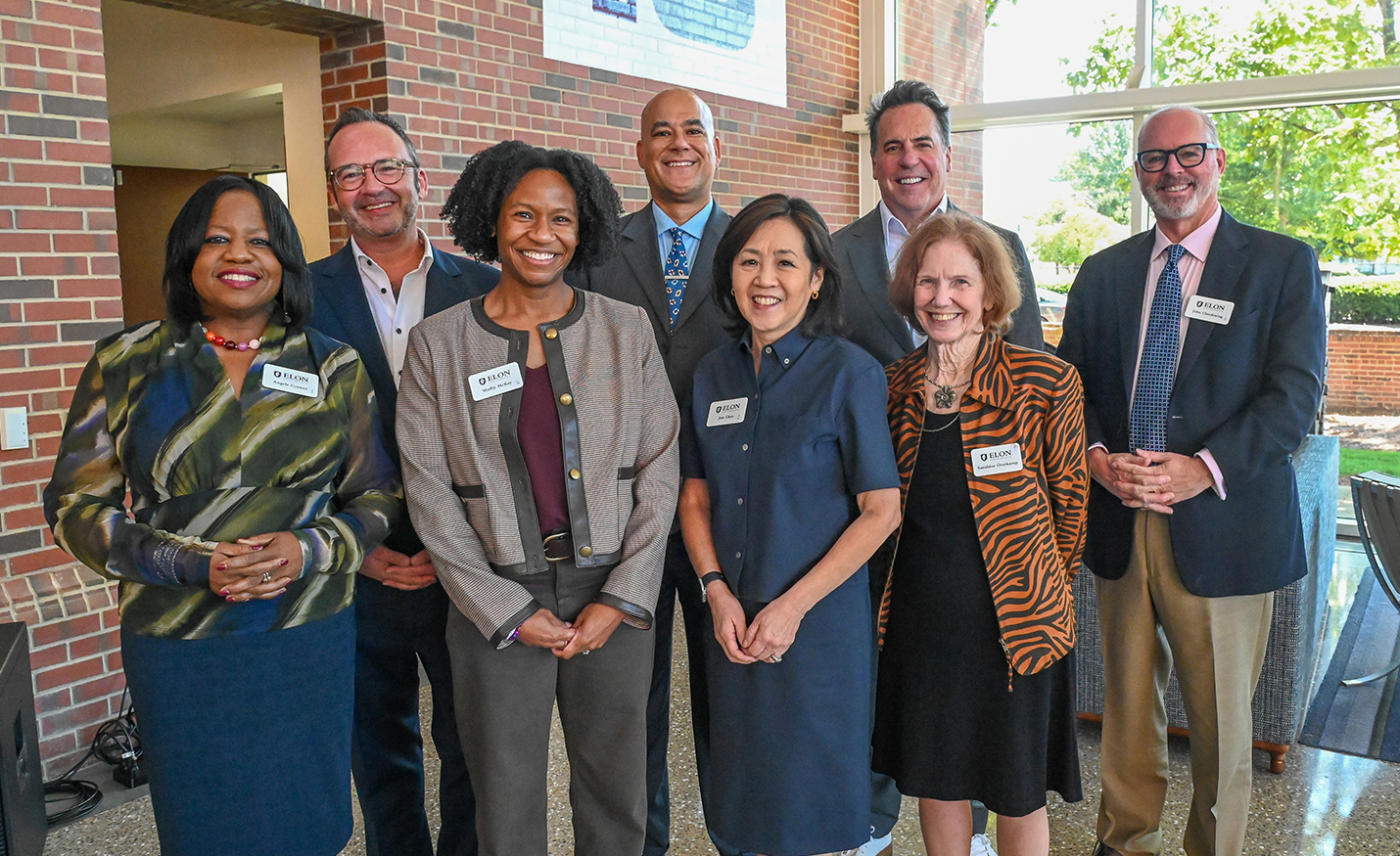 Members of the school's national advisory board pose in Snow Family Grand Atrium. 