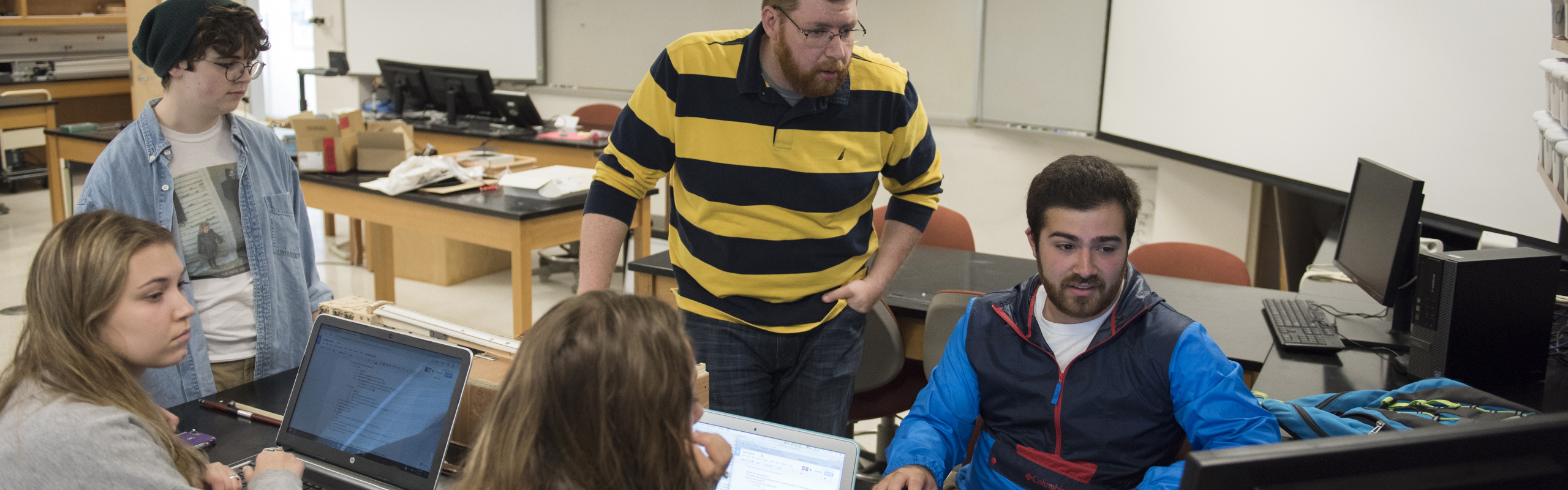Matt Sears '18 works with students and Jeremy Hohertz, Instructor in Physics