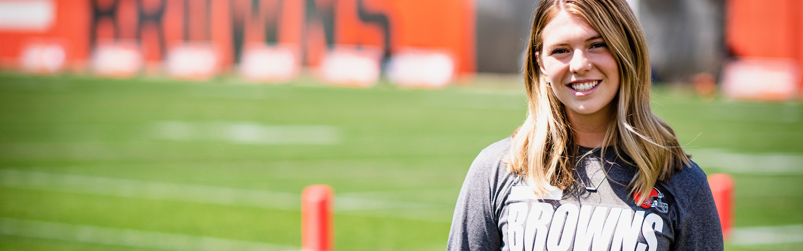 Hach smiles while on a Cleveland Browns practice field.