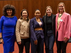 A group of female leaders stand together for a photo during the Elon WINS Forum.