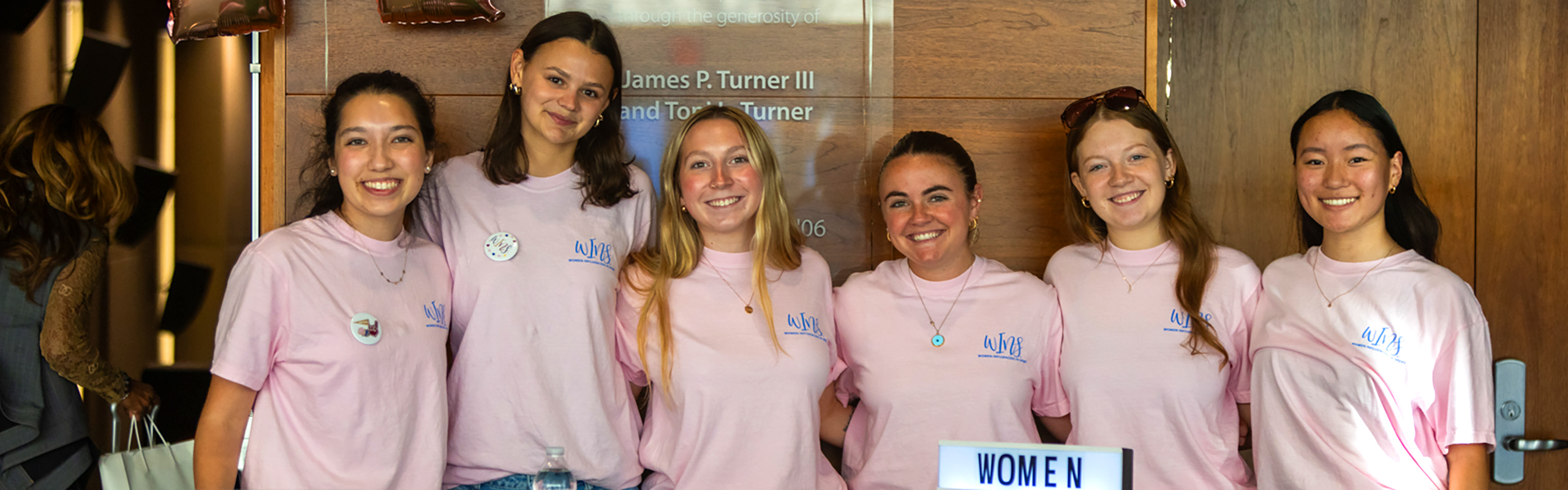 Members of WINS stand together