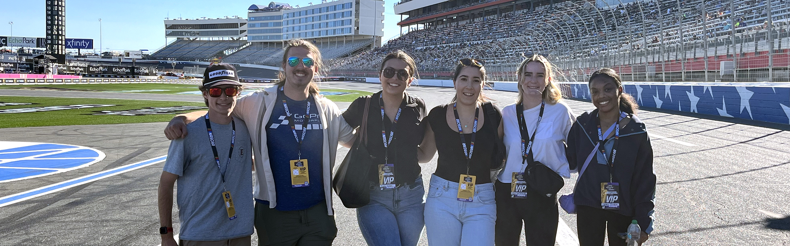 ���ϲ����� students in The Sport & Community Experience program visit Charlotte Motor Speedway, experiencing the track up close.