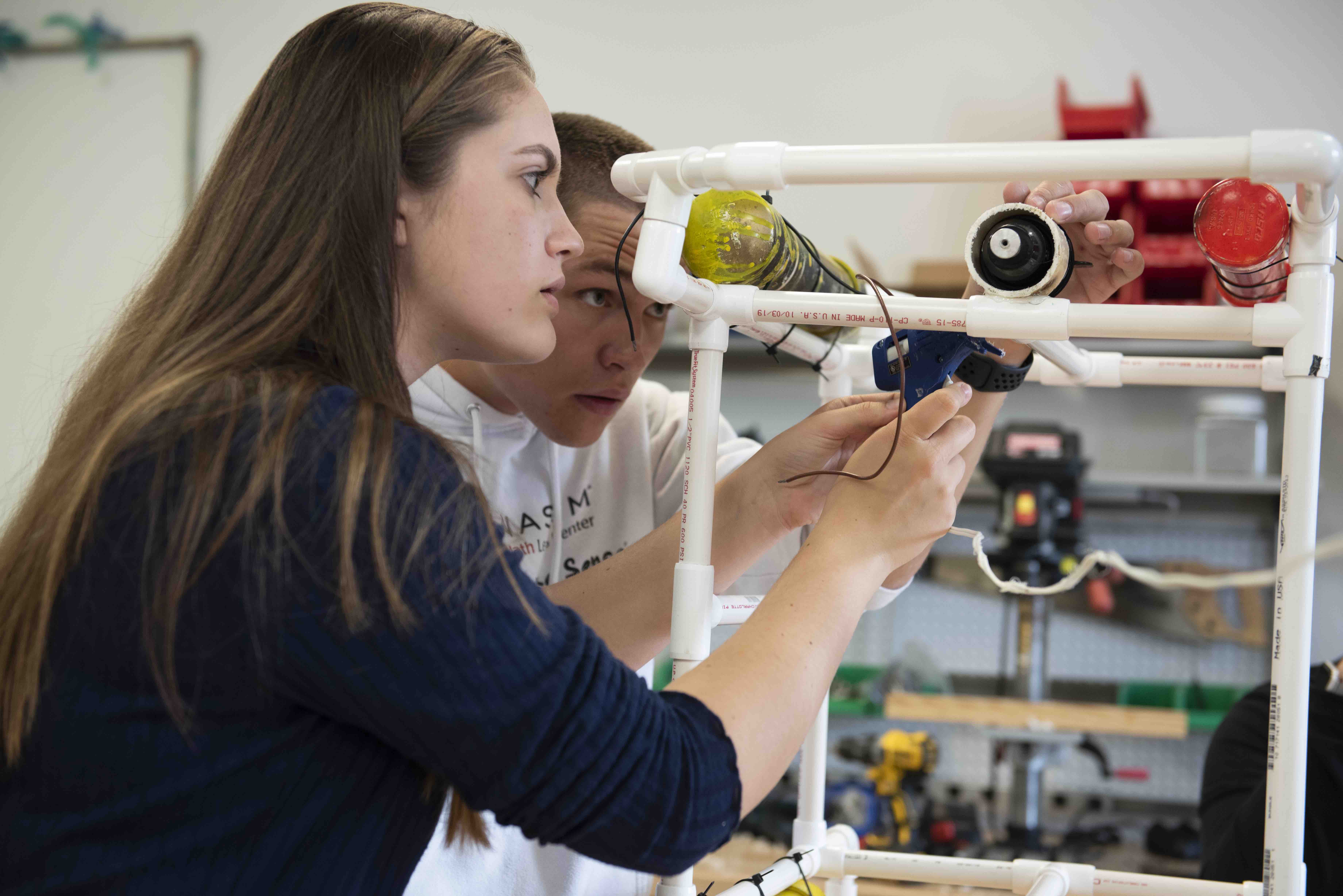 Associate Professor of Engineering Scott Wolter works with students in his Grand Challenges for Engineering class in the engineering workshop on campus. They are designing and constructing underwater remotely-operated-vehicles