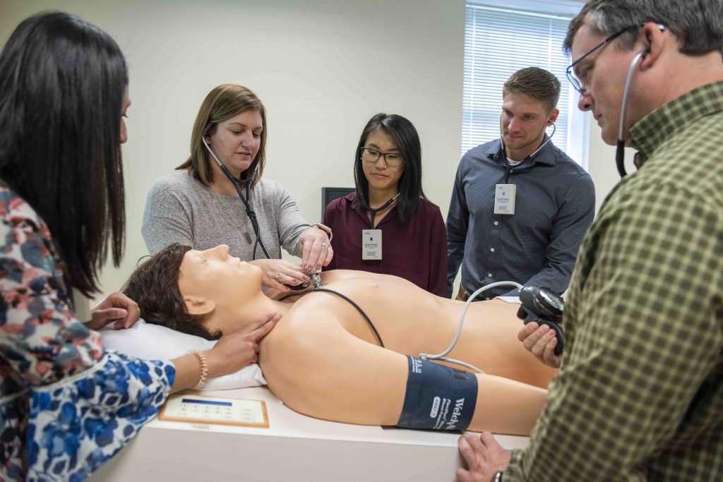 Assistant Professor of Physician Assistant Studies Tracey Thurnes and her students work with “Harvey,” a cardiopulmonary patient simulator.