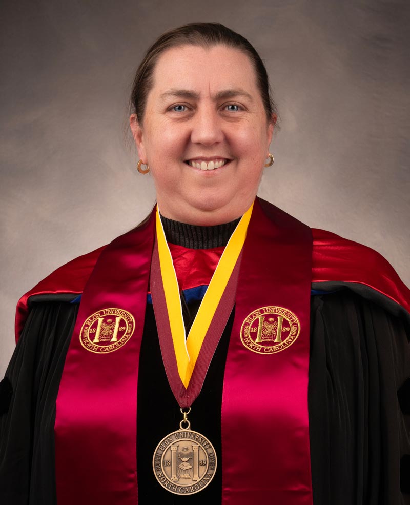 Distinguished University Professor Ann Cahill in regalia with stole and Elon University medallion.