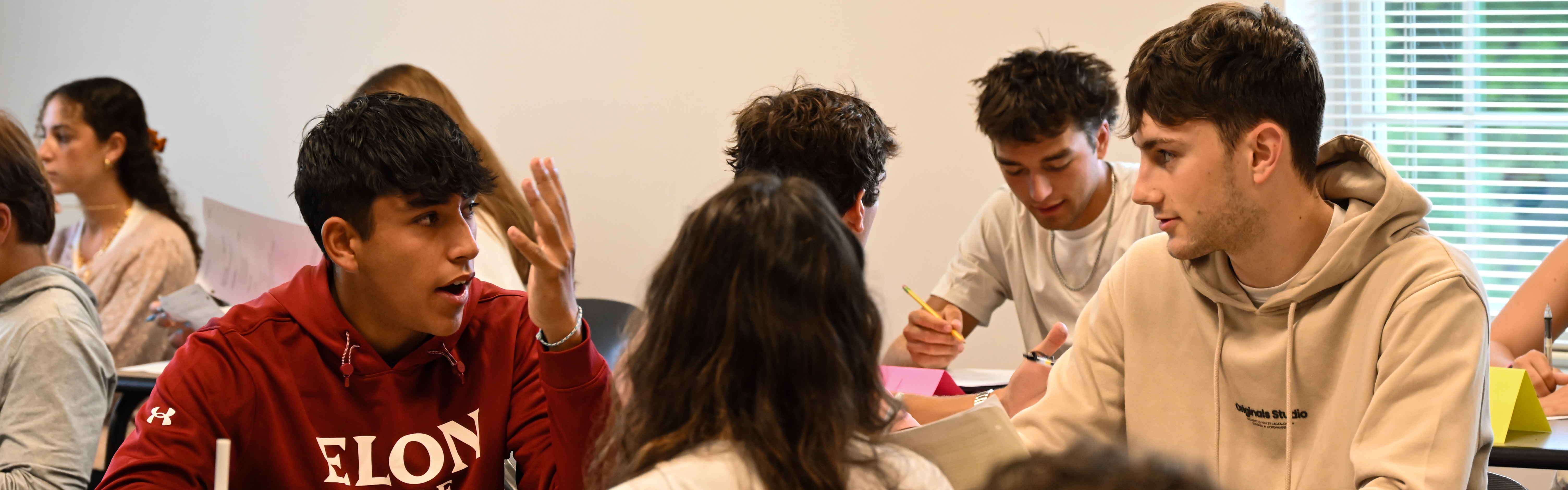 Photo of Love School of Business Students conversing in the classroom