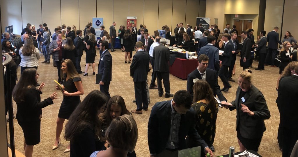 Photo of students talking with recruiters in a large room. 