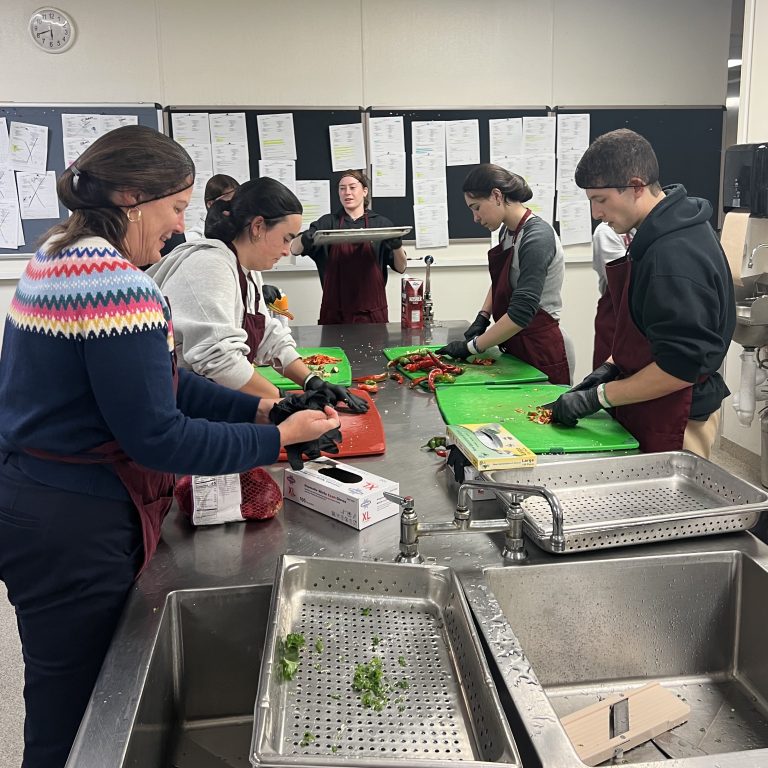 A group of students prepares food.