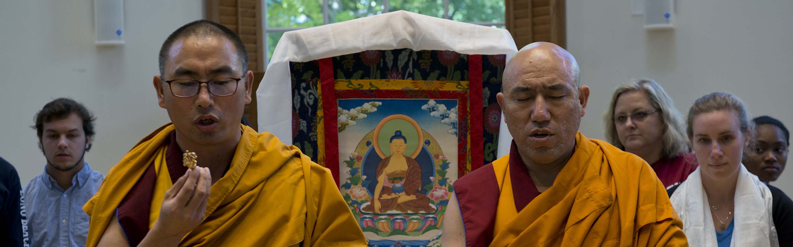 Buddhist monks from the Kadampa Center in Raleigh during the sand mandala closing ceremony. The two destroyed the completed mandala by swirling the various colors into the center of the display.