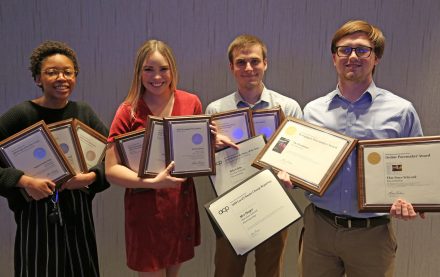 Student media leaders holding awards.