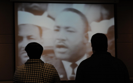 Two people watching Martin Luther King Jr.'s "I Have a Dream" speech.