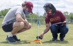 Andrew Jackson '21 and Associate Professor of Engineering Sirena Hargrove-Leak prepare his team's rocket for launch. Jackson, a finance major, wanted to take an engineering class before he graduated.