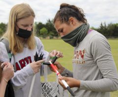 Mary Hermes '24, left, helps Arianna Sakoutis with her team's rocket.