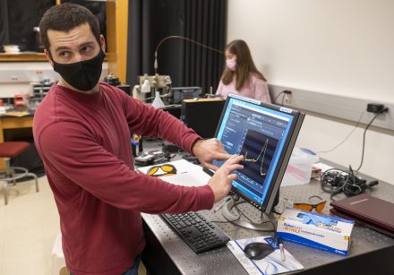 Dr. Anthony Rizzuto explains the project Anna Sheinberg ’22 is working on in the laser lab of McMichael Science Center, Tuesday, Feb. 22, 2022. (Rob Brown photo)
