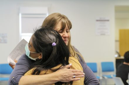 Tiffany Huang '23 and instructor of English Chrissy Stein embrace after introducing Huang's essay about her struggle to find community at Elon as an interracial woman.