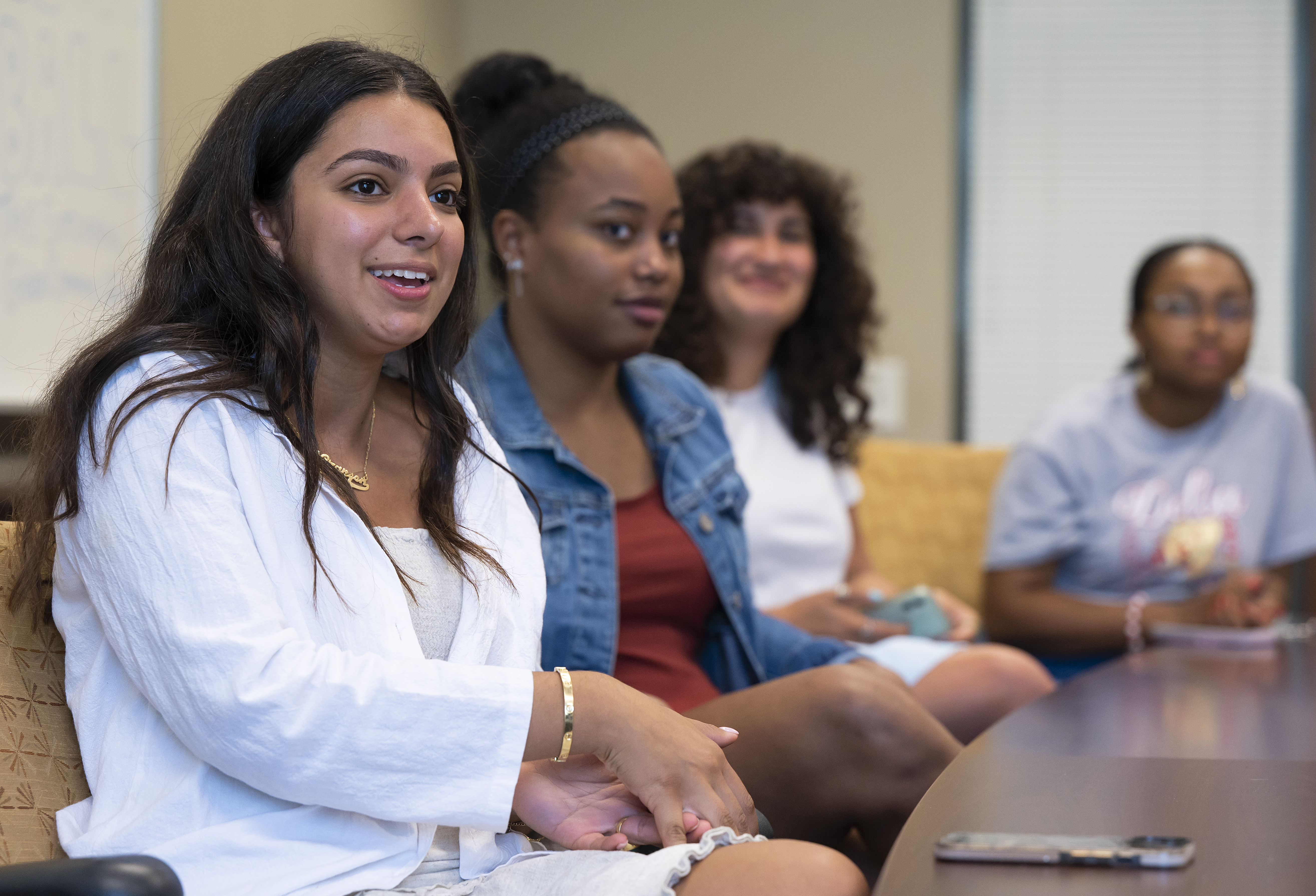 Left to right, students Nazaneen Shokri ’24, Mia Wilson ’22, Deena Elrefai ’22, and Queen Assata Stephens ’22 speak about their experiences with the H.E.R. Lab, Monday, April 11, 2022 at Elon University. (Rob Brown photo)