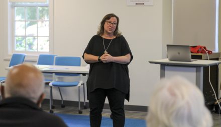 Professor of Religious Studies Toddie Peters addresses members of the Morrowtown Community Group during Poverty and Social Justice capstone presentations May 10.