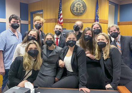 Ten members of Elon's mock trial team pose inside Atlanta courtroom.