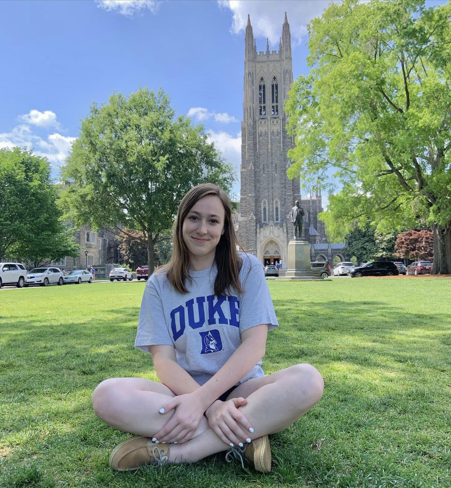 Samantha Eastman sitting on a lawn at Duke University, where she will pursue a Ph.D in Chemistry.