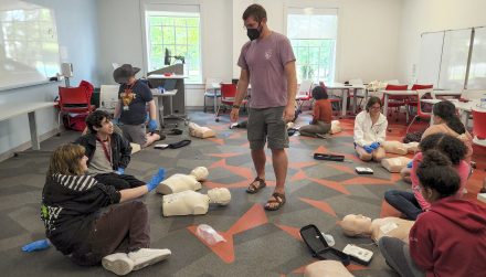 Assistant Director of Campus Recreation and Wellness for Experiential Learning Evan Small teaches CPR to Elon Freedom Scholars.